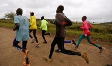 Athletes from South Sudan, part of the refugee athletes who qualified for the 2016 Rio Olympics, and their training partners run along a dusty road during a jogging session at their camp in Ngong township near Kenya's capital Nairobi, June 9, 2016. PHOTO BY REUTERS/Thomas Mukoya