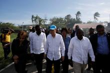 UN Secretary General Ban Ki Moon (C) and Haitian interim Prime Minister Enex Jean-Charles (2nd L) walk in the MINUSTAH base during a visit after Hurricane Matthew in Les Cayes, Haiti, October 15, 2016. PHOTO BY REUTERS/Andres Martinez Casares