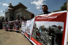 People hold banners showing victims of Saudi-led air strikes during a demonstration outside the United Nations offices in Sanaa, Yemen, August 29, 2017. PHOTO BY REUTERS/Khaled Abdullah