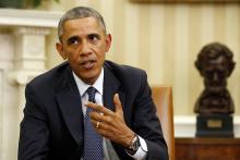 U.S. President Barack Obama talks to the press after meeting with his team coordinating the government's Ebola response in the Oval Office of the White House in Washington