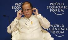 Philippine President Benigno Aquino listens on his headset during the opening plenary session of the World Economic Forum on East Asia, at Manila's Makati financial district