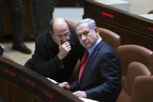 Israel's Defence Minister Moshe Yaalon (L) speaks with Prime Minister Benjamin Netanyahu during a session of the Knesset, the Israeli parliament, in Jerusalem, December 1, 2014. PHOTO BY REUTERS/Ronen Zvulun