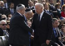 Israel's Prime Minister Benjamin Netanyahu (L) shakes hands with U.S. Vice President Joe Biden (C) at a memorial ceremony for former Israeli Prime Minister Ariel Sharon at the Knesset, Israel's parliament, in Jerusalem