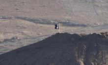 A black flag belonging to the Islamic State is seen near the Syrian town of Kobani, as pictured from the Turkish-Syrian border near the southeastern town of Suruc in Sanliurfa province, October 6, 2014. PHOTO BY REUTERS/Umit Bektas