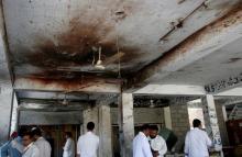Men gather under a ceiling with blood stain, after twin bomb attack occurred at a court, in Mardan, Pakistan, September 2, 2016. PHOTO BY REUTERS/Khuram Parvez
