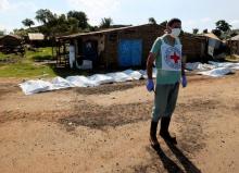 A worker from the International Committee of the Red Cross (ICRC) prepares to move bags containing bodies of unidentified people killed in the recent fighting in checkpoint area of Juba, South Sudan, July 16, 2016. PHOTO BY REUTERS/Stringer