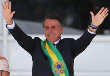 Brazil's new President Jair Bolsonaro gestures after receiving the presidential sash from outgoing President Michel Temer at the Planalto Palace, in Brasilia, Brazil, January 1, 2019. PHOTO BY REUTERS/Sergio Moraes