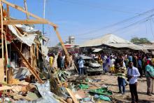 Civilians gather near the scene of a suicide bomb explosion at the Wadajir market in Madina district of Somalia's capital Mogadishu, February 19, 2017. PHOTO BY REUTERS/Feisal Omar