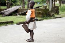 A boy holding a cutlass stands in a street in Ikarama village on the outskirts of the Bayelsa state capital, Yenagoa, in Nigeria's delta region, October 8, 2015. PHOTO BY REUTERS/Akintunde Akinleye