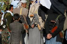 A boy stands behind armed Houthi followers attending a rally to celebrate the killing of Yemen's former president Ali Abdullah Saleh in Sanaa, Yemen December 5, 2017. PHOTO BY REUTERS/Khaled Abdullah