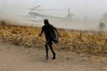 A boy moves away as a United Nations World Food Programme (WFP) helicopter lands in Rubkuai village, Unity State, northern South Sudan, February 18, 2017. PHOTO BY REUTERS/Siegfried Modola