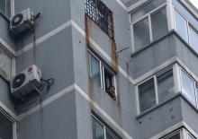 Guzailai Nu'er, the wife of Ilham Tohti, speaks as she has an interview with Reuters by a phone from window of her house in Beijing