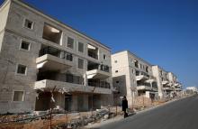 An ultra-Orthodox Jewish man walks past buildings under construction in the Israeli settlement of Beitar Ilit, in the occupied West Bank, December 22, 2016. PHOTO BY REUTERS/Baz Ratner