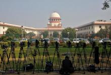 A television journalist sets his camera inside the premises of the Supreme Court in New Delhi, India, February 18, 2014. PHOTO BY REUTERS/Anindito Mukherjee