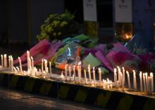 Lighted candles and flowers are pictured outside Resorts World during a memorial for those killed in a casino fire caused by a gunman in Pasay City, Metro Manila Philippines, June 2, 2017. PHOTO BY REUTERS/Dondi Tawatao