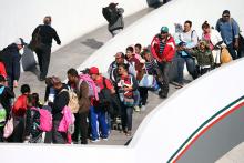 Members of a caravan of migrants from Central America, enter the United States border and customs facility, where they are expected to apply for asylum, in Tijuana, Mexico, May 4, 2018. PHOTO BY REUTERS/Edgard Garrido