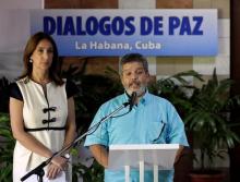 Revolutionary Armed Forces of Colombia (FARC) negotiator Marcos Carratala reads a document next to Colombian government spokeswoman Marcela Duran in Havana, Cuba, June 22, 2016. PHOTO BY REUTERS/Enrique de la Osa