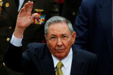 Cuba's President Raul Castro waves to supporters during a ceremony to swear Venezuela's President Nicolas Maduro (not pictured) into office, in Caracas, April 19, 2013. PHOTO BY REUTERS/Carlos Garcia Rawlins