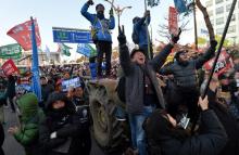 People react after impeachment vote on South Korean President Park Geun-hye was passed, in front of the National Assembly in Seoul, South Korea, December 9, 2016. The sign reads "Arrest Park Geun-hye". PHOTO BY REUTERS
