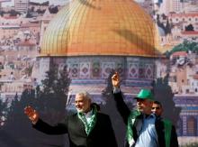 Hamas Chief Ismail Haniyeh and Gaza's Hamas Chief Yehya Al-Sinwar gesture to supporters during a rally marking the 30th anniversary of Hamas' founding, in Gaza City, December 14, 2017. PHOTO BY REUTERS/Mohammed Salem