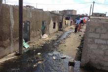 Children walk down an alleyway where sewage runs freely in Pikine, Senegal, October 16, 2015. PHOTO BY REUTERS/Makini Brice