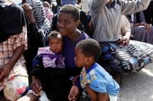 An illegal African migrant sits with his children during a visit by U.N. Special Representative and Head of the United Nations Support Mission in Libya Martin Kobler and International Organization for Migration Director General William Lacy Swing at a detention camp in Tripoli, Libya, March 22, 2017. PHOTO BY REUTERS/Ismail Zitouny
