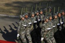 Soldiers of the Chinese People's Liberation Army march during their drill ahead of their year-end review in Jiaxing, Zhejiang province