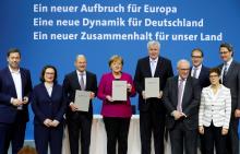 German Chancellor and leader of the Christian Democratic Union (CDU) Angela Merkel, leader of the Christian Social Union (CSU) Horst Seehofer and leader of the Social Democratic Party (SPD) Olaf Scholz present signed coalition deal during a ceremony in Berlin, Germany, March 12, 2018. PHOTO BY REUTERS/Fabrizio Bensch