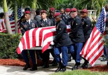 An honor guard carries the coffin of U.S. Army Sergeant La David Johnson, who was among four special forces soldiers killed in Niger, at a graveside service in Hollywood, Florida, October 21, 2017. PHOTO BY REUTERS/Joe Skipper