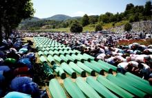 Muslim men pray in front of coffins during mass funeral in Potocari near Srebrenica, Bosnia and Herzegovina, July 11, 2016. PHOTO BY REUTERS/Dado Ruvic