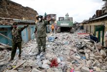 Rescue workers gesture as they search the rubble of a collapsed five-storey building where at least three people have been confirmed dead and several are feared trapped inside, in a residential area of Nairobi, Kenya, June 3, 2018. PHOTO BY REUTERS/Baz Ratner