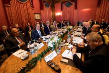 Conference participants speak together around a table during a bilateral meeting where they discussed the crisis in Syria, in Lausanne, Switzerland, October 15, 2016. PHOTO BY REUTERS/Jean-Christophe Bott
