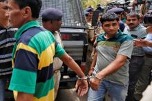 A convict in connection with a riot in Gujarat in 2002 are escorted by police at a court before a hearing in Ahmedabad, India, June 17, 2016. PHOTO BY REUTERS/Amit Dave