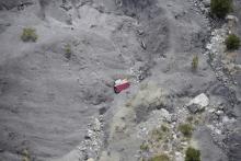 An aerial photo taken from a helicopter shows the crash site of the Germanwings Airbus A320 and its debris on the mountainside near Seyne-les-Alpes, April 3, 2015. PHOTO BY REUTERS/Lionel Bonaventure