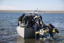 Crew members of the blockaded Ukrainian naval landing vessel "Konstantin Olshansky" come ashore after leaving the ship in Donuzlav bay in Crimea