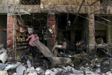 A man inspects damaged shops after an airstrike on a market in the town of Maarat al-Numan in the insurgent stronghold of Idlib province, Syria, April 19, 2016. PHOTO BY REUTERS/Ammar Abdullah