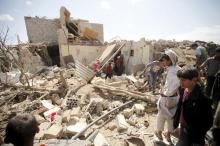 People inspect damage at a house after it was destroyed by a Saudi-led air strike in Yemen's capital Sanaa, February 25, 2016. PHOTO BY REUTERS/Mohamed al-Sayaghi