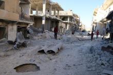 People inspect a damaged site after airstrikes on the rebel held Sheikh Fares neighbourhood of Aleppo, Syria, October 1, 2016. PHOTO BY REUTERS/Abdalrhman Ismail