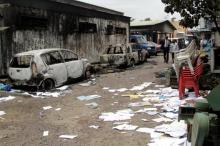 Congolese civilians walk past a house and vehicles which were burnt during anti-government protests to press President Joseph Kabila to step down in the Democratic Republic of Congo's capital Kinshasa, September 21, 2016. PHOTO BY REUTERS/Kenny Katombe