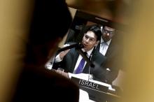 Israel's Ambassador to the United Nations Danny Danon is seen on a screen in an interpreters booth as he addresses a United Nations Security Council meeting on the Middle East at U.N. headquarters in New York, January 26, 2016. PHOTO BY REUTERS/Mike Segar