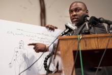 Brown family attorney Daryl Parks points on an autopsy diagram, on August 18, 2014, to one of the wounds Michael Brown sustained when he was shot by the police