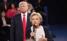 Donald Trump listens as Hillary Clinton answers a question from the audience, October 9, 2016. PHOTO BY REUTERS/Rick Wilking