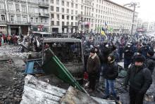 Demonstrators gather at a barricade during a rally held by pro-European integration protesters in Kiev