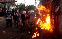 Demonstrators burn the Sandinista radio station during clashes with riot police during a protest against Nicaragua's President Daniel Ortega's government in Managua, May 30. PHOTO BY REUTERS/Oswaldo Rivas