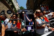 Demonstrators hold pictures of Ahmet Nesin, Sebnem Korur Fincanci and Erol Onderoglu during a protest against arrest of the three prominent campaigners for press freedom, in front of the pro-Kurdish Ozgur Gundem newspaper in central Istanbul, Turkey, June 21, 2016. PHOTO BY REUTERS/Murad Sezer
