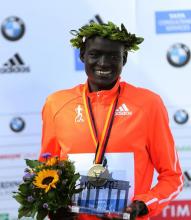 Dennis Kimetto of Kenya holds his trophy as he celebrates during the awards ceremony for the 41st Berlin marathon