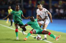 Mauritania's Moustapha Diaw in action with Tunisia's Oussama Haddadi and Mauritania's Ismael Diakite. PHOTO BY REUTERS/Suhaib Salem