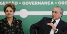 Brazil's President Dilma Rousseff (L) reacts next to Vice President Michel Temer during a ceremony to announce measures to modernize Brazilian soccer at the Planalto Palace in Brasilia, March 19, 2015. PHOTO BY REUTERS/Ueslei Marcelino