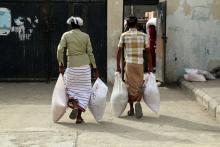 Displaced people receive aid kits distributed by the (ICRC) International Committee of the Red Cross in the war-torn Red Sea port city of Hodeidah, Yemen, June 21, 2018. PHOTO BY REUTERS/Abduljabbar Zeyad