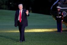U.S. President Donald Trump waves as walks on the South Lawn of the White House upon his return to Washington, U.S., from the G20 Summit in Hamburg, July 8, 2017. PHOTO BY REUTERS/Yuri Gripas